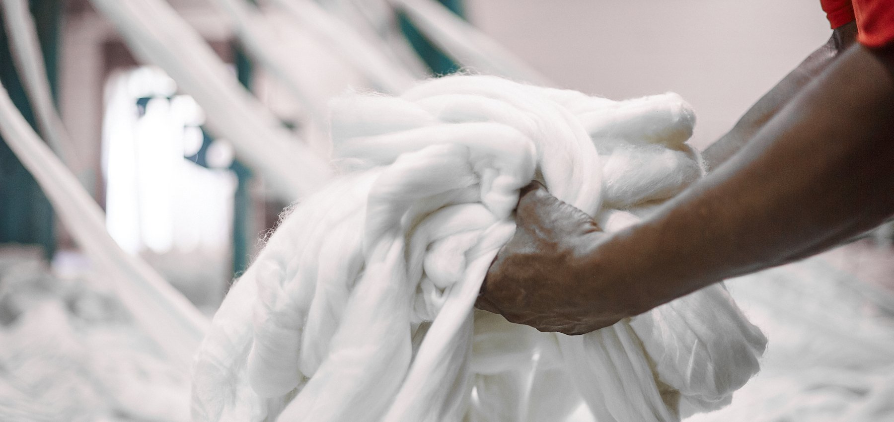 man holding pile of wool