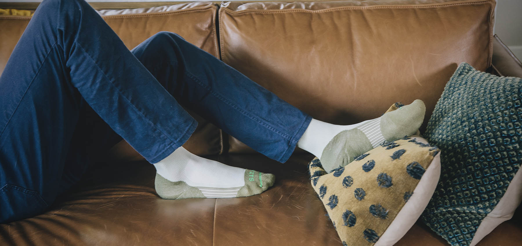 Woman on couch wearing FITS socks