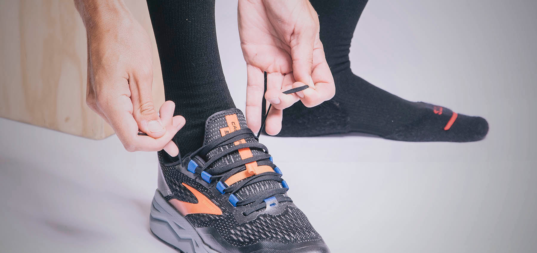 Man wearing FITS Socks tying shoes