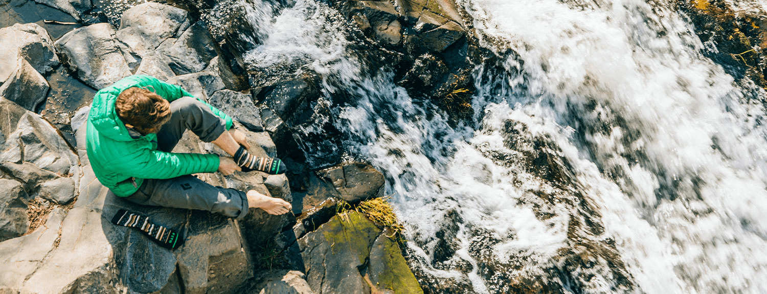 man looking at water fall